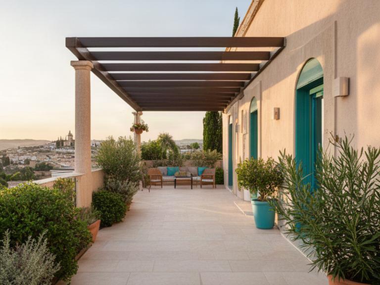 Entrada de una terraza reformada en Priego de Córdoba con pavimento exterior y pérgola